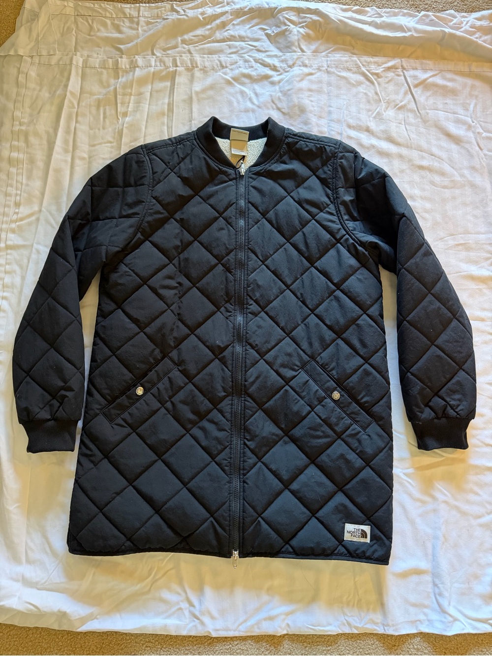 The North Face women’s Black Quilted Long Jacket.